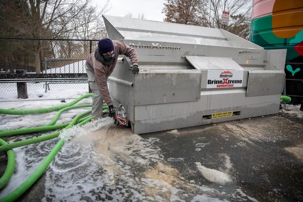 Engineer Brian McLane releases water from the brine mixing tank before starting a new batch of brine. (Robin Lubbock/WBUR)