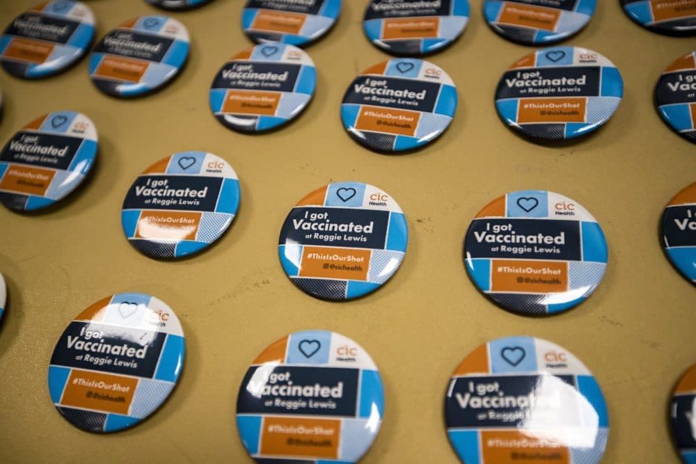 I got vaccinated” buttons on a table for recipients of the Pfizer BioNTech vaccine to take on their way out of the Reggie Lewis Center. (Jesse Costa/WBUR)