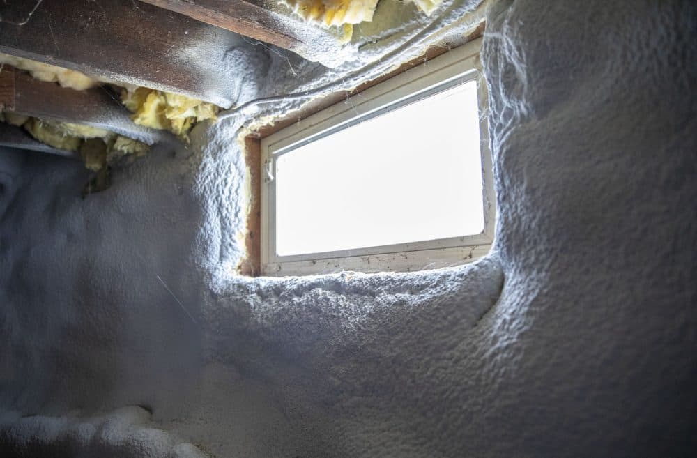 The basement wall in a renovated triple-decker, where the old stone wall has been covered with a hard layer of foam insulation. (Robin Lubbock/WBUR)