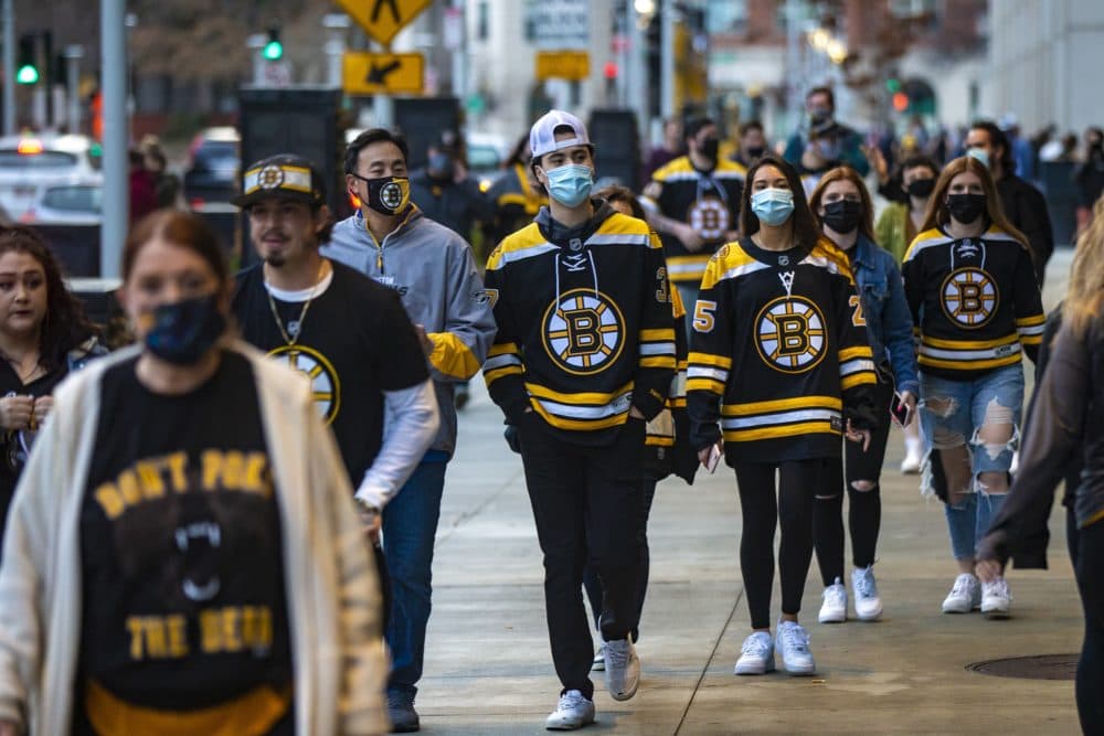 Bruins fans walk down Causeway Street on their way to the game. (Jesse Costa/WBUR)
