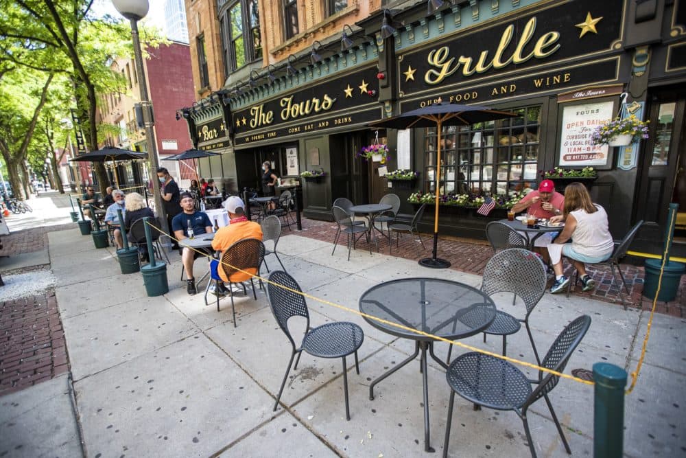 Diners eat lunch and have a few drinks at The Fours near North Station on the first day restaurants were allowed to serve patrons on their premises outdoors following the pandemic shutdown in 2020. (Jesse Costa/WBUR)