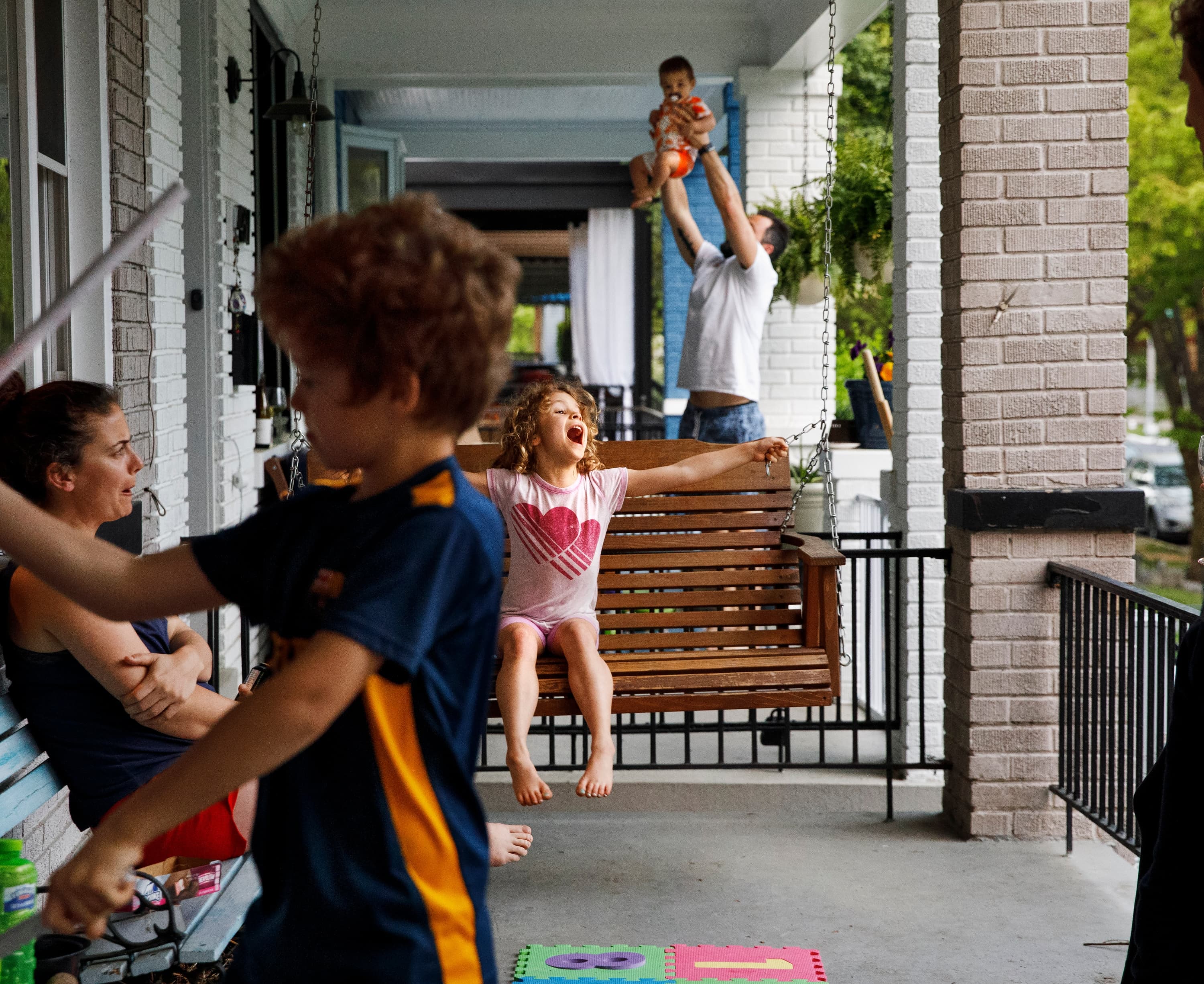 Families in Washington spend extra time on their porches, as social distancing rules set in, on April 5, 2020. (Jacquelyn Martin/AP)