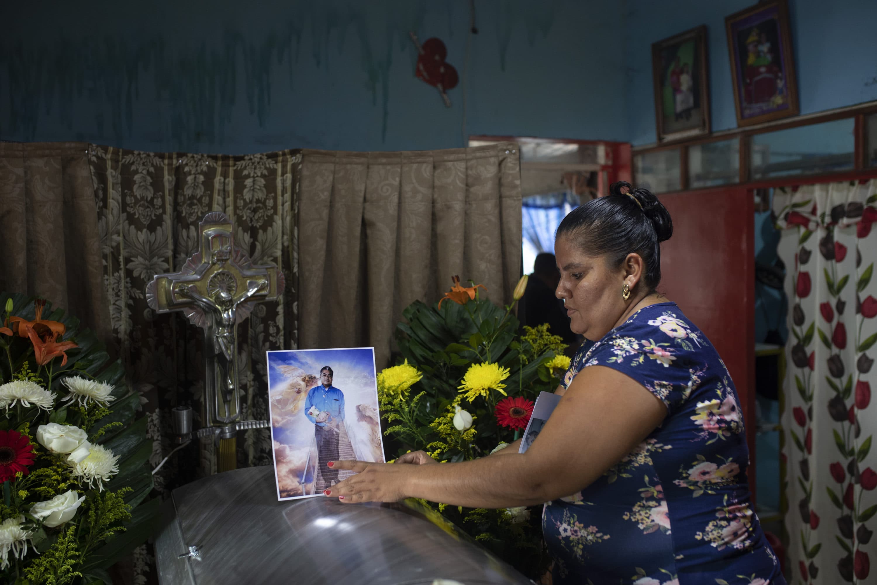 A woman places a photo of slain journalist Julio Valdivia on his casket during a wake for him inside his home in Tezonapa, Mexico, on Sept. 10, 2020. Valdivia's decapitated body was found five miles from Tezonapa a day earlier, and is at least the third reporter killed in the area since 2015. (Felix Marquez/AP)
