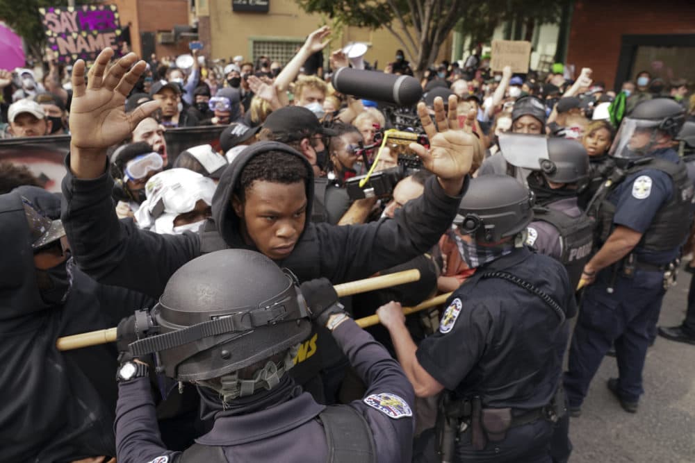 Police and protesters converge during a Black Lives Matter demonstration in Louisville, Kentucky, in Sept. 2020. (John Minchillo/AP)