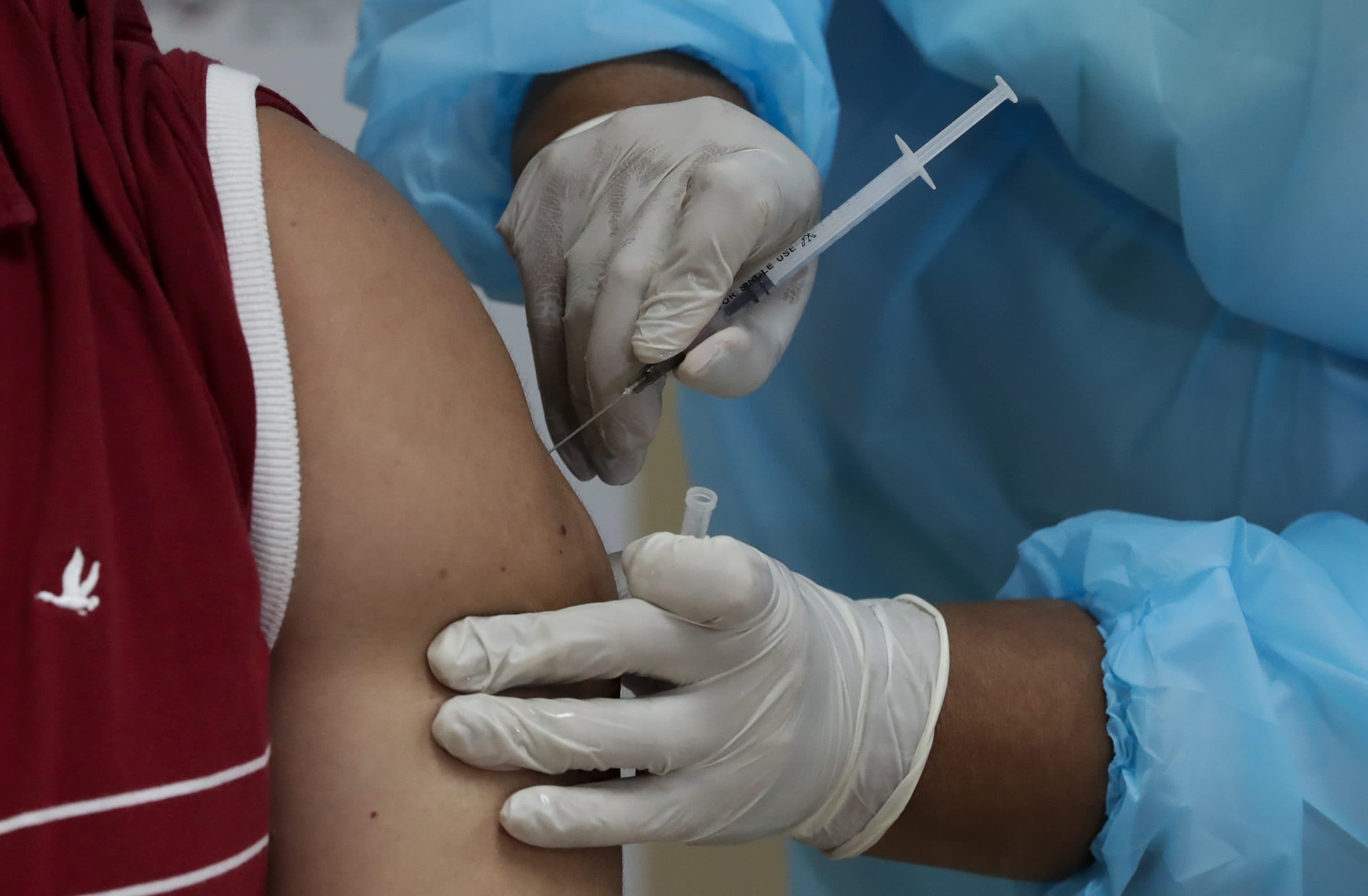 A health worker gets a second shot of the Pfizer-BioNTech vaccine for COVID-19 at Santo Tomas Hospital in Panama City. (AP Photo/Arnulfo Franco)