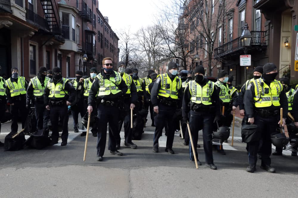 In this Jan. 17, 2021, file photo, Boston police officers stand in a street in the Beacon Hill neighborhood near the Statehouse in Boston as a precaution against demonstrations following the breach of the U.S. Capitol earlier in the month.(Michael Dwyer/AP File)