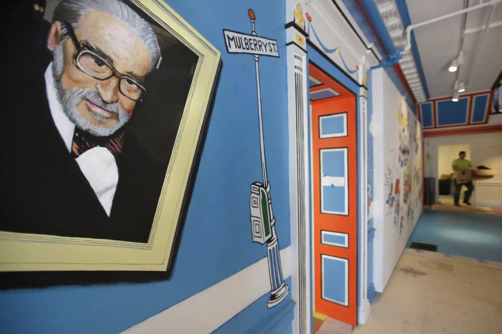 In this May 4, 2017, file photo, a mural that features Theodor Seuss Geisel, left, also known by his pen name Dr. Seuss, covers part of a wall near an entrance at The Amazing World of Dr. Seuss Museum, in Springfield, Mass.(Steven Senne/AP File)