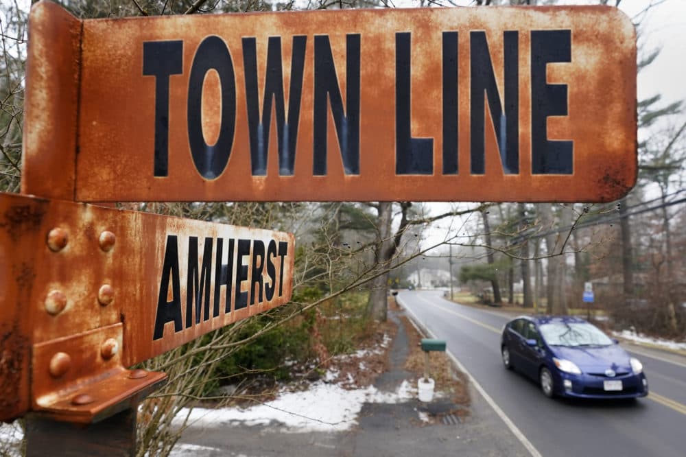 A car rolls past a rusted town line sign, Jan. 15, 2021, in Amherst, Mass. (Charles Krupa/AP)