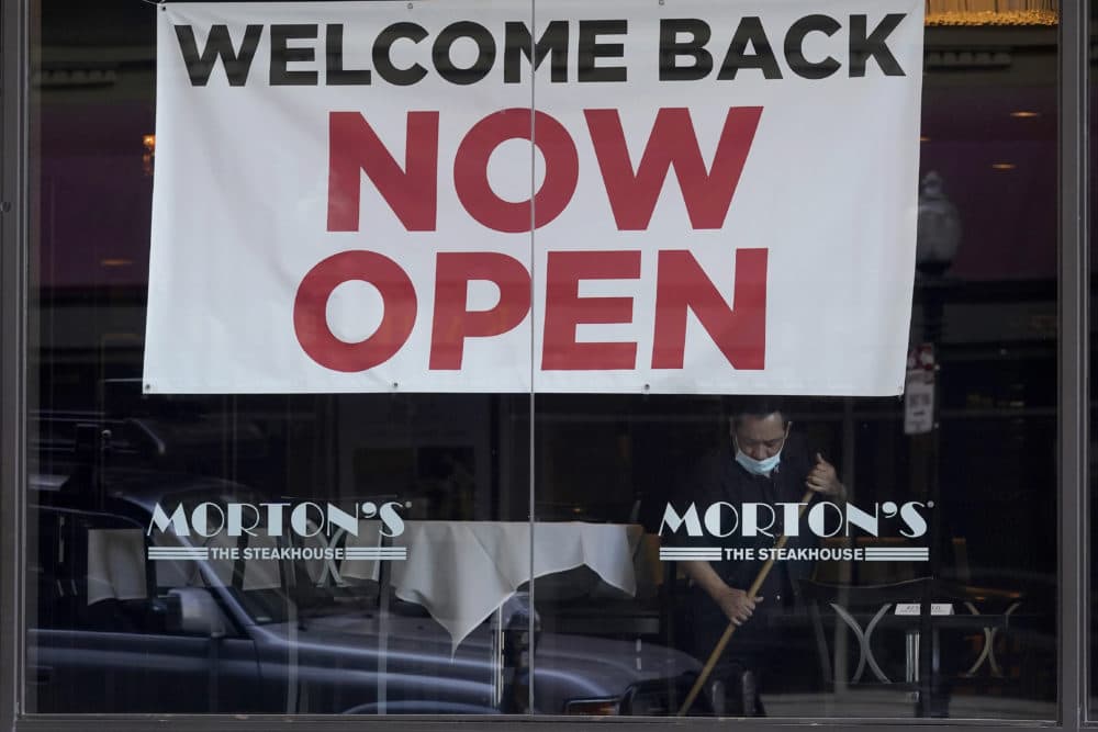 In this March 4, 2021, file photo, a sign reading "Welcome Back Now Open" is posted on the window of a Morton's Steakhouse restaurant as a man works inside during the coronavirus pandemic in San Francisco. (Jeff Chiu/AP File)