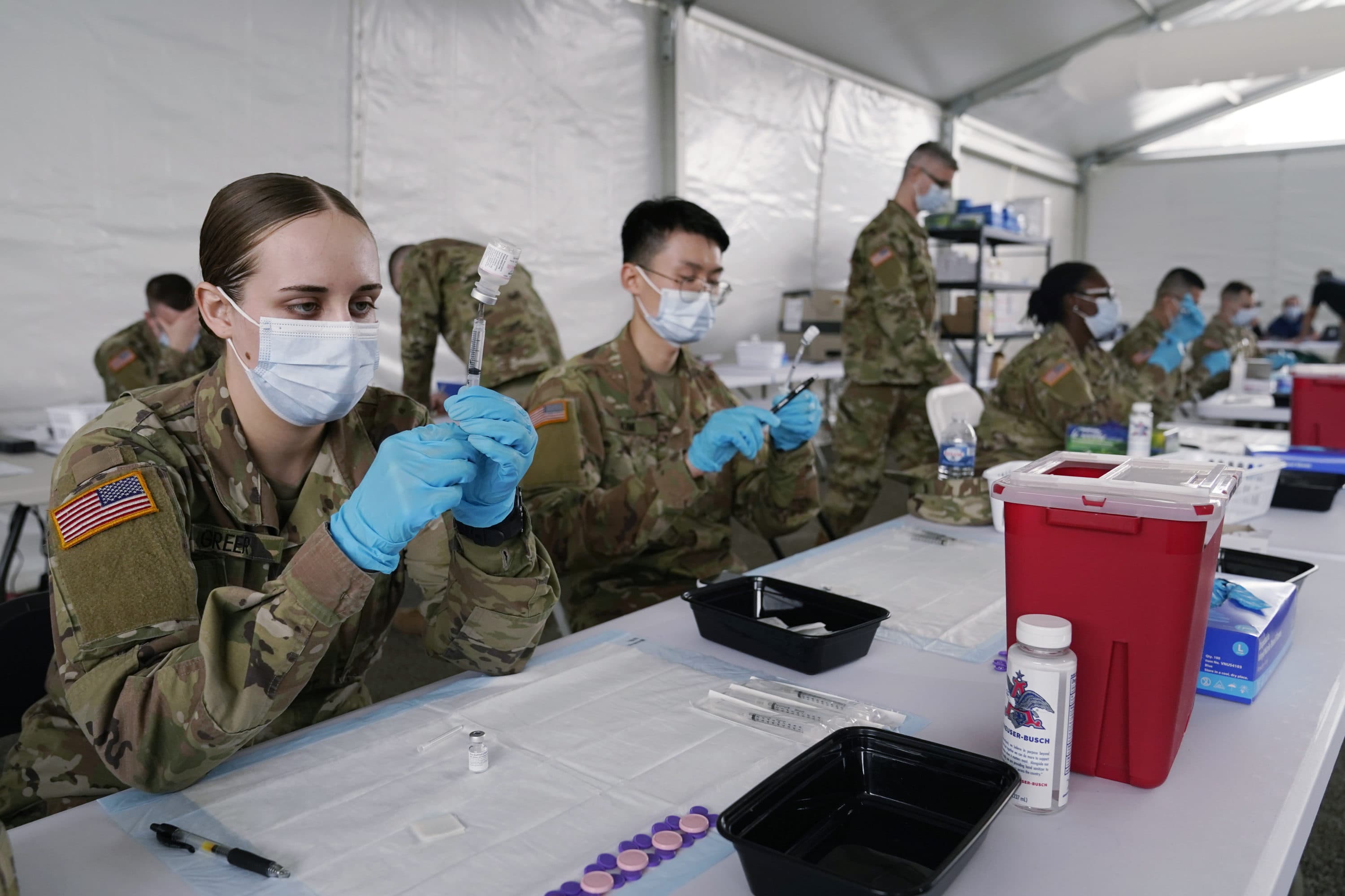 In this March 9, 2021, file photo, Army health specialists fill syringes with the Pfizer COVID-19 vaccine in Miami. Despite the clamor to speed up the U.S. vaccination drive against COVID-19, the first three months of the rollout suggest faster is not necessarily better. (Marta Lavandier/AP File)