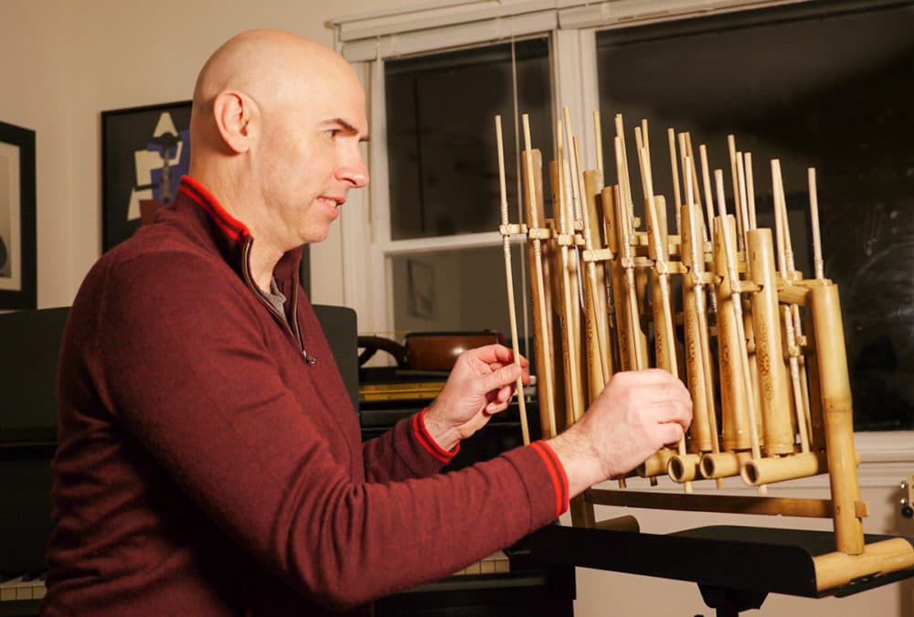 Eric Shimelonis playing an angklung, generously provided to Circle Round by Rya Cox. (Photo courtesy of Rebecca Sheir)