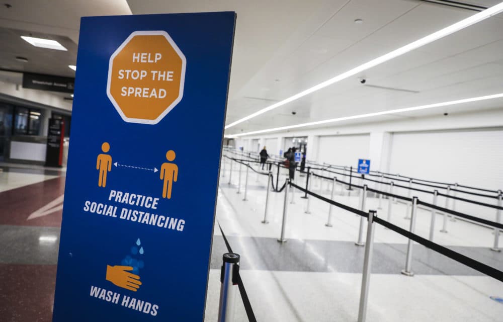 A sign encouraging people to stop the spread of coronavirus sits at a nearly empty security checkpoint at Logan International Airport in Boston on Nov. 27, 2020. (Erin Clark/The Boston Globe via Getty Images)