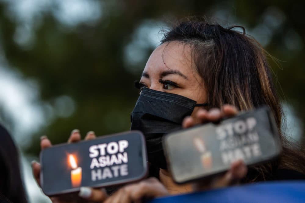 Clover Tran holds her phone during a candlelight vigil in Garden Grove, California, on March 17, 2021 to unite against the recent spate of violence targeting Asians, and to express grief and outrage after yesterday's shooting that left eight people dead in Atlanta, including at least six Asian women. (APU GOMES/AFP via Getty Images)