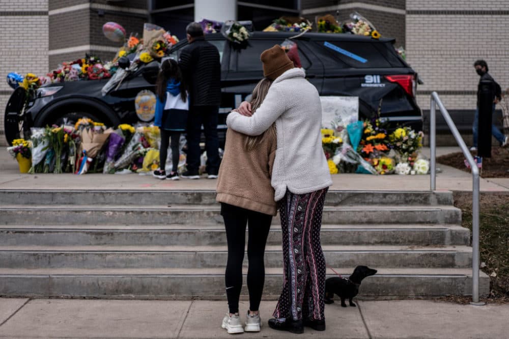 BOULDER, CO - MARCH 23: Sarah O'Keefe and Maura Kieft pay their respects to Officer Eric Talley, who was killed after a gunman opened fire at a King Sooper's grocery store on March 23, 2021 in Boulder, Colorado. (Photo by Chet Strange/Getty Images)