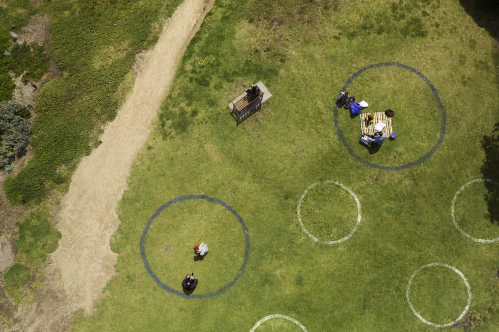 In Melbourne, Australia, circles of different colors and sizes drawn on the grass during the COVID-19 pandemic to keep social distancing. (Monica Bertolazzi/Getty)