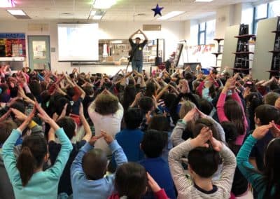 The author teaching "This Land is Your Land" at an elementary school, 2018. (Courtesy)