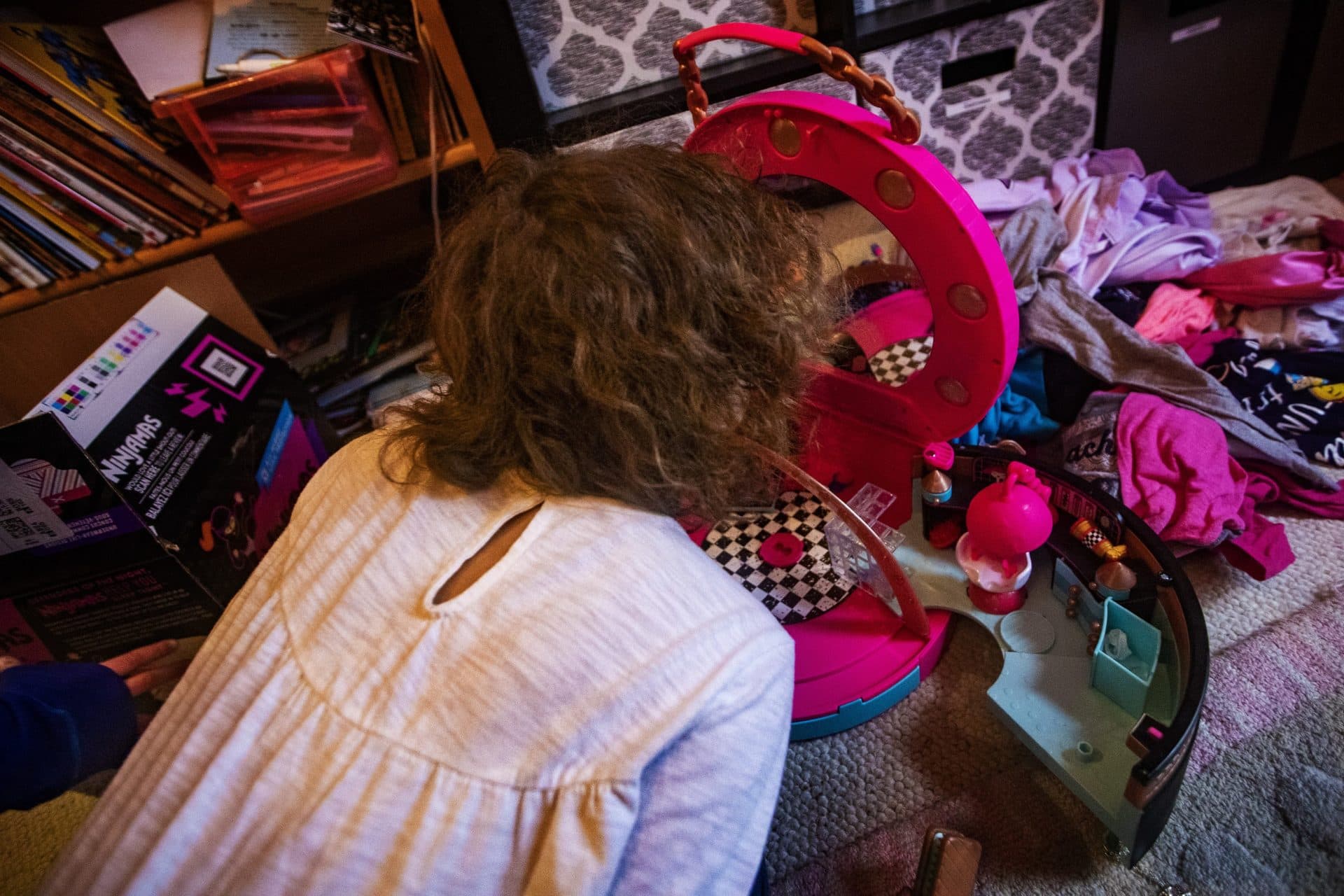 Hallel looks in the mirror to see the hair chalk they put into their hair. (Jesse Costa/WBUR)