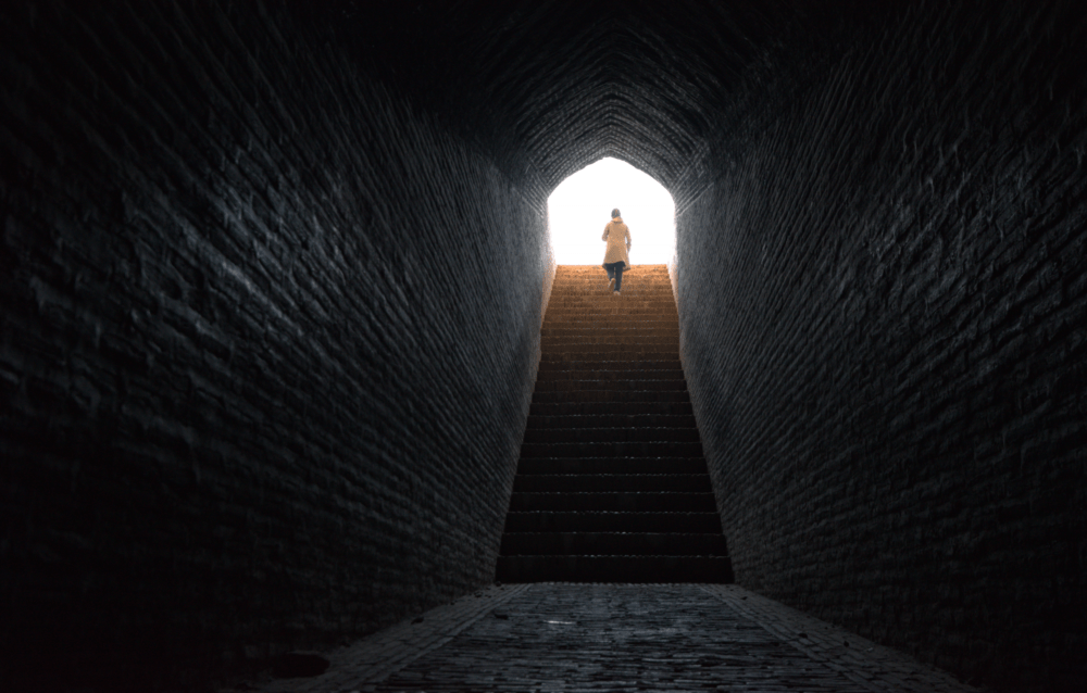 Woman walks up stairs  from a tunnel in Iran. (Getty)