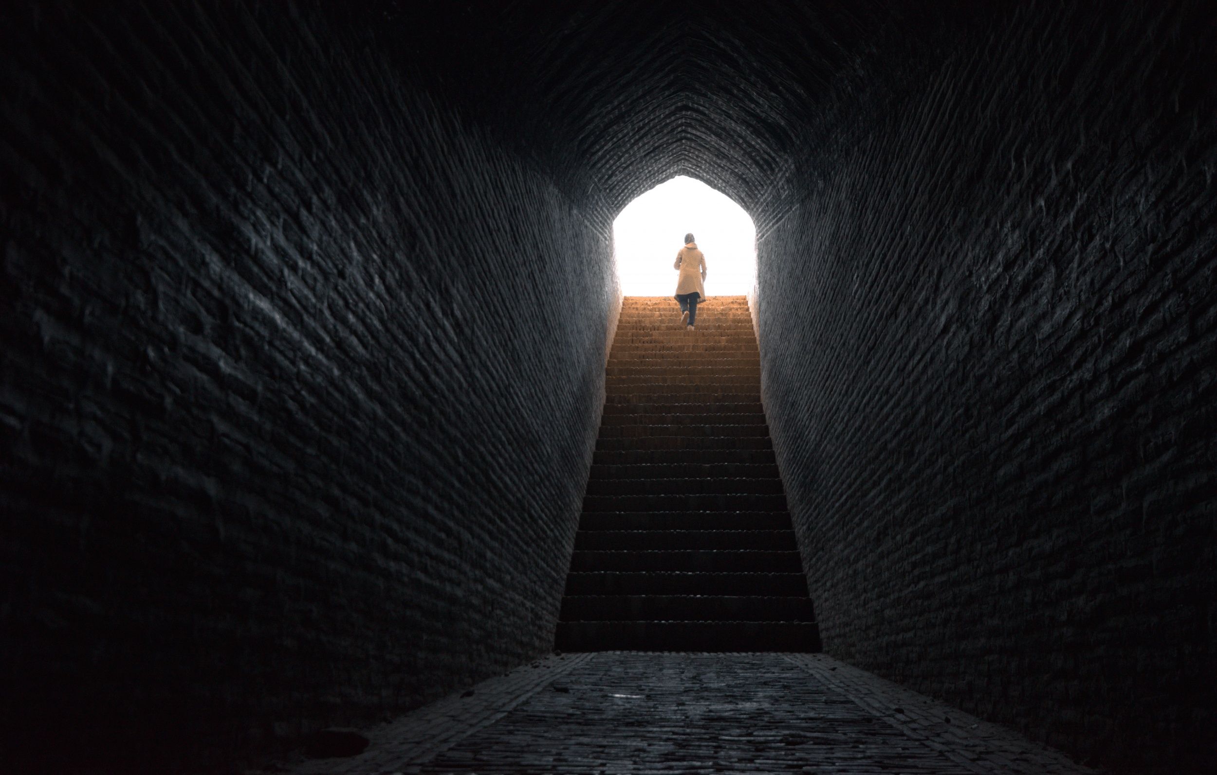 Woman walks up stairs from a tunnel in Iran. (Getty)