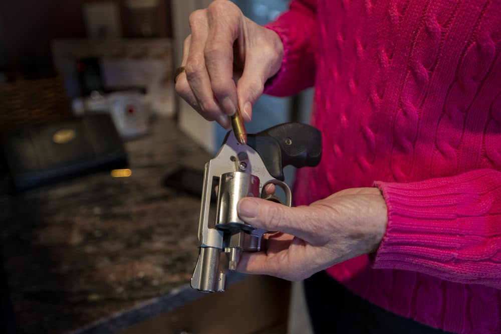 A woman loads her Smith and Wesson revolver. (Jesse Costa/WBUR)