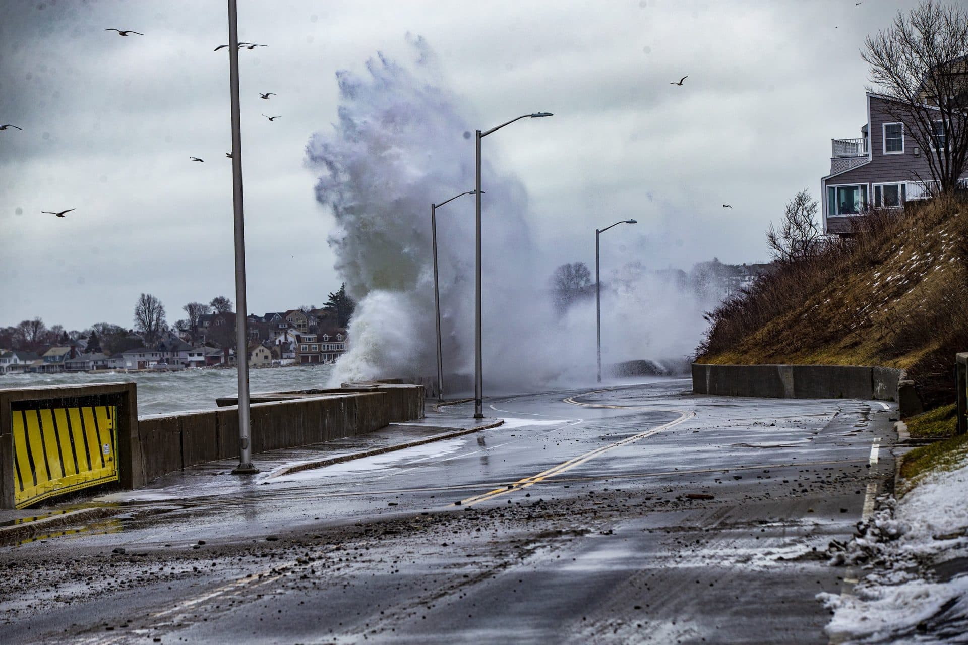 Water crashes along the seawall on Winthrop Parkway during a recent high tide. (Jesse Costa/WBUR)
