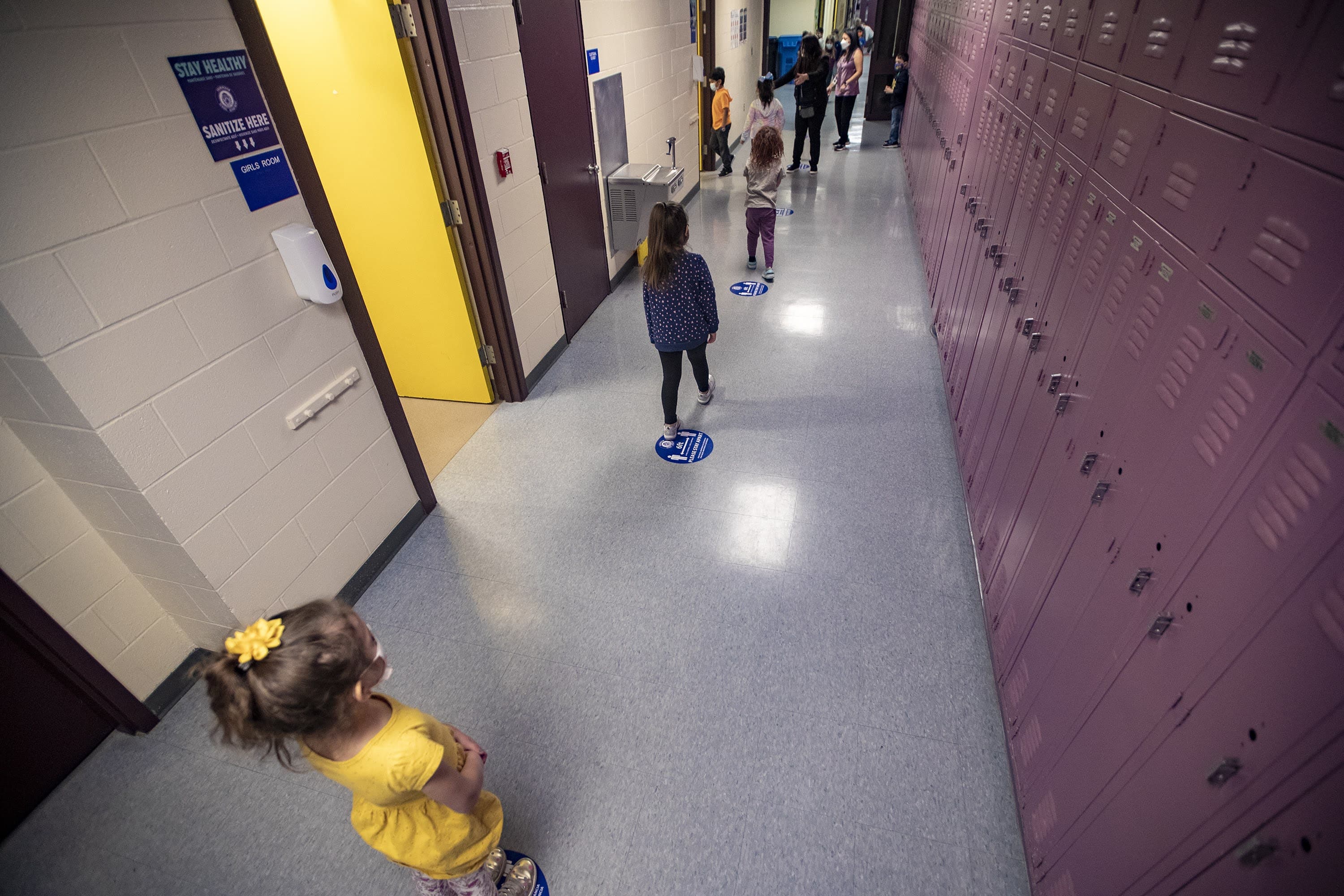 Students maintain six feet of distancing during a bathroom break at Barbieri Elementary School in Framingham. (Jesse Costa/WBUR)