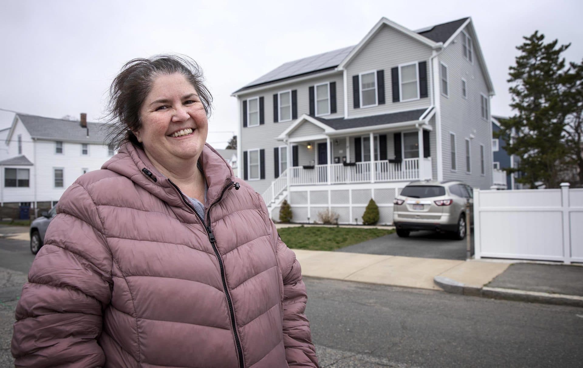 Samantha's aunt, Sandra Castellarin, standing across the street from her house on Pearl Avenue. (Robin Lubbock/WBUR)