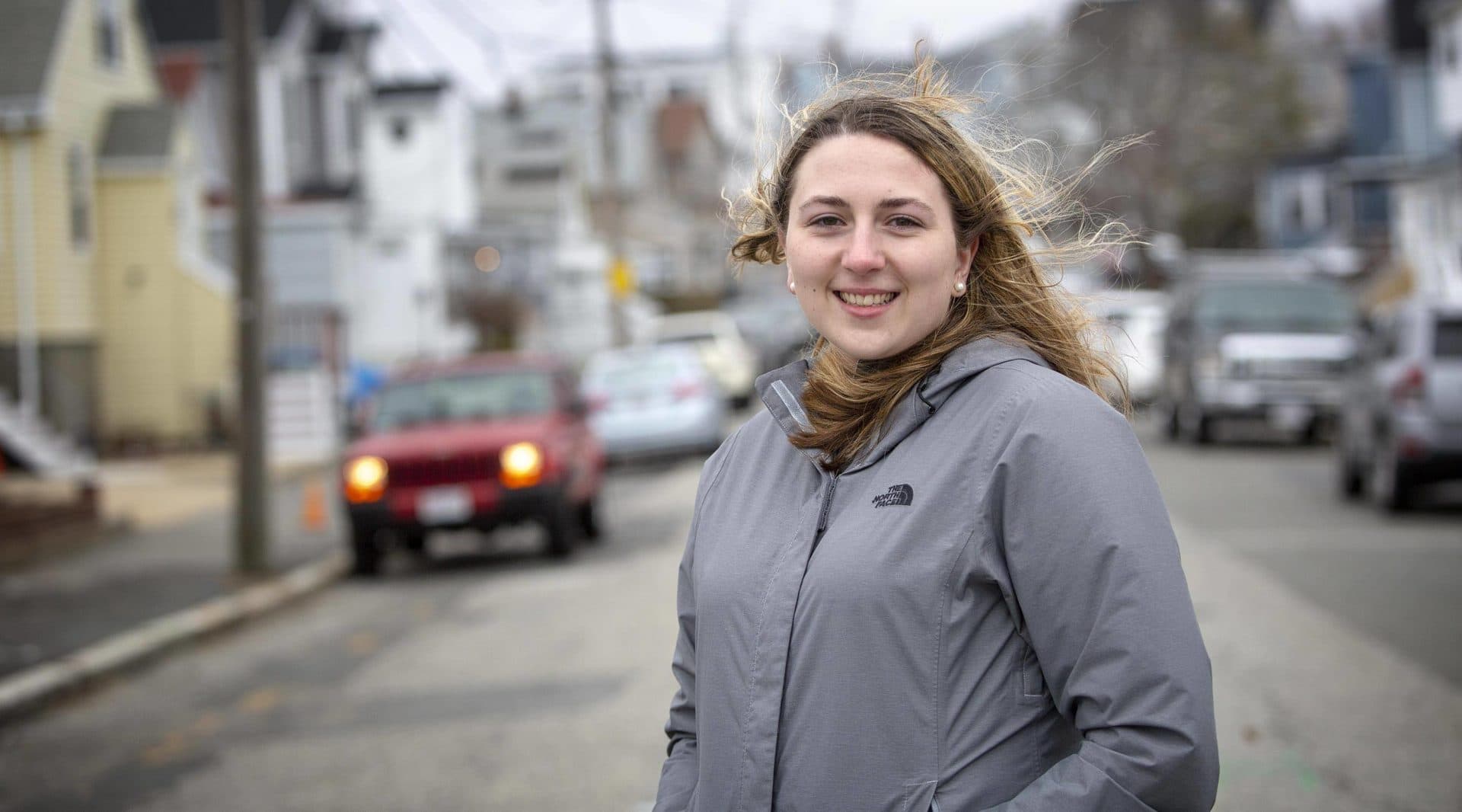 Samantha Woodman stands on Pearl Avenue near her childhood home. (Robin Lubbock/WBUR)