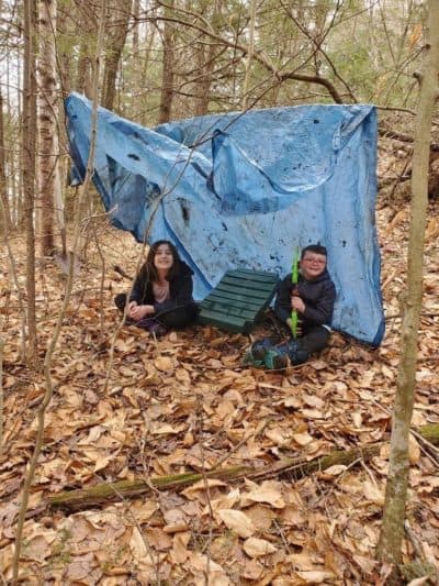 Crystal Gagnon’s kids, who are homeschooled, have spent a lot of the pandemic in the woods behind their Meredith cabin. (Sarah Gibson/NHPR)