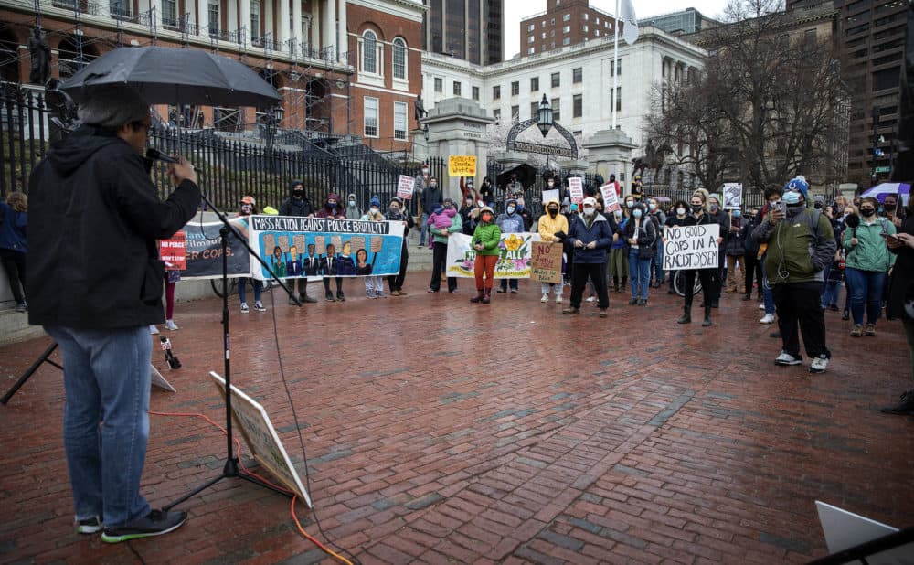 Brock Satter, a co-founder of Mass Action Against Police Brutality, speaks to protesters in front of the Massachusetts State House. (Robin Lubbock/WBUR)