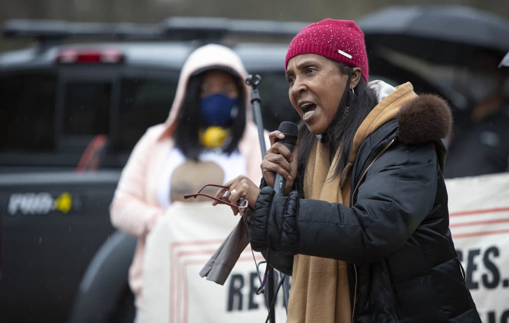 Carla Sheffield, mother of Burrell Ramsey-White, who was shot by police in 2012, speaks at the Mass Action Against Police Brutality rally. (Robin Lubbock/WBUR)