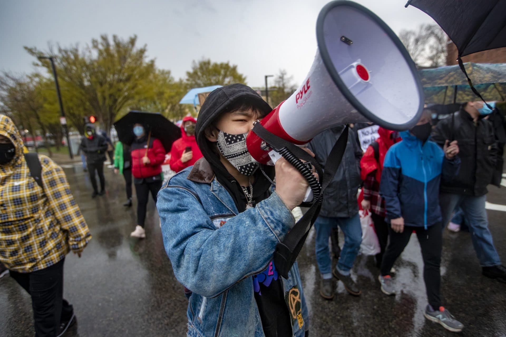 About one hundred protesters march down Malcolm X Boulevard in the rain during the Violence for Boston rally. (Jesse Costa/WBUR)