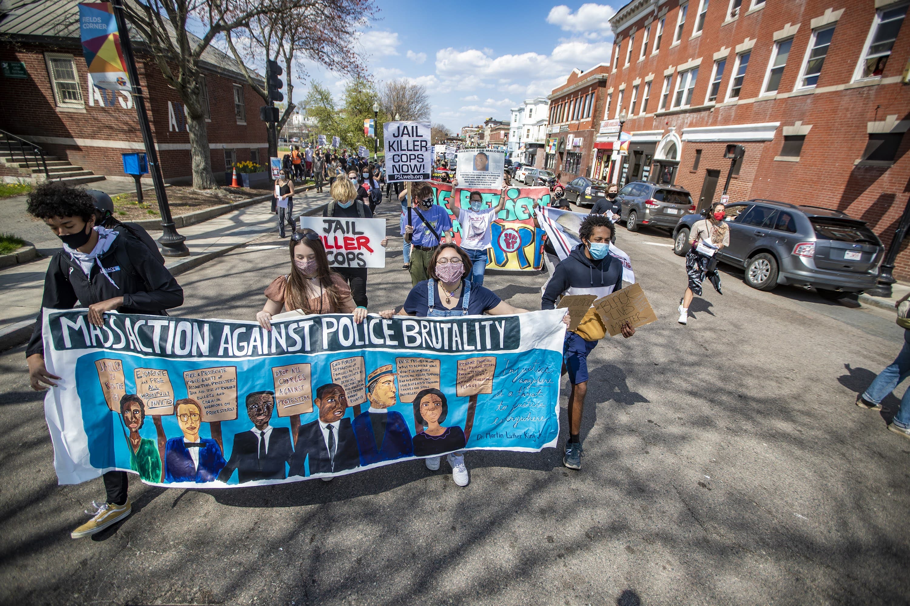 Protesters begin marching down Dorchester Avenue in Fields Corner during the Mass. Action Against Police Brutality rally and march. (Jesse Costa/WBUR)