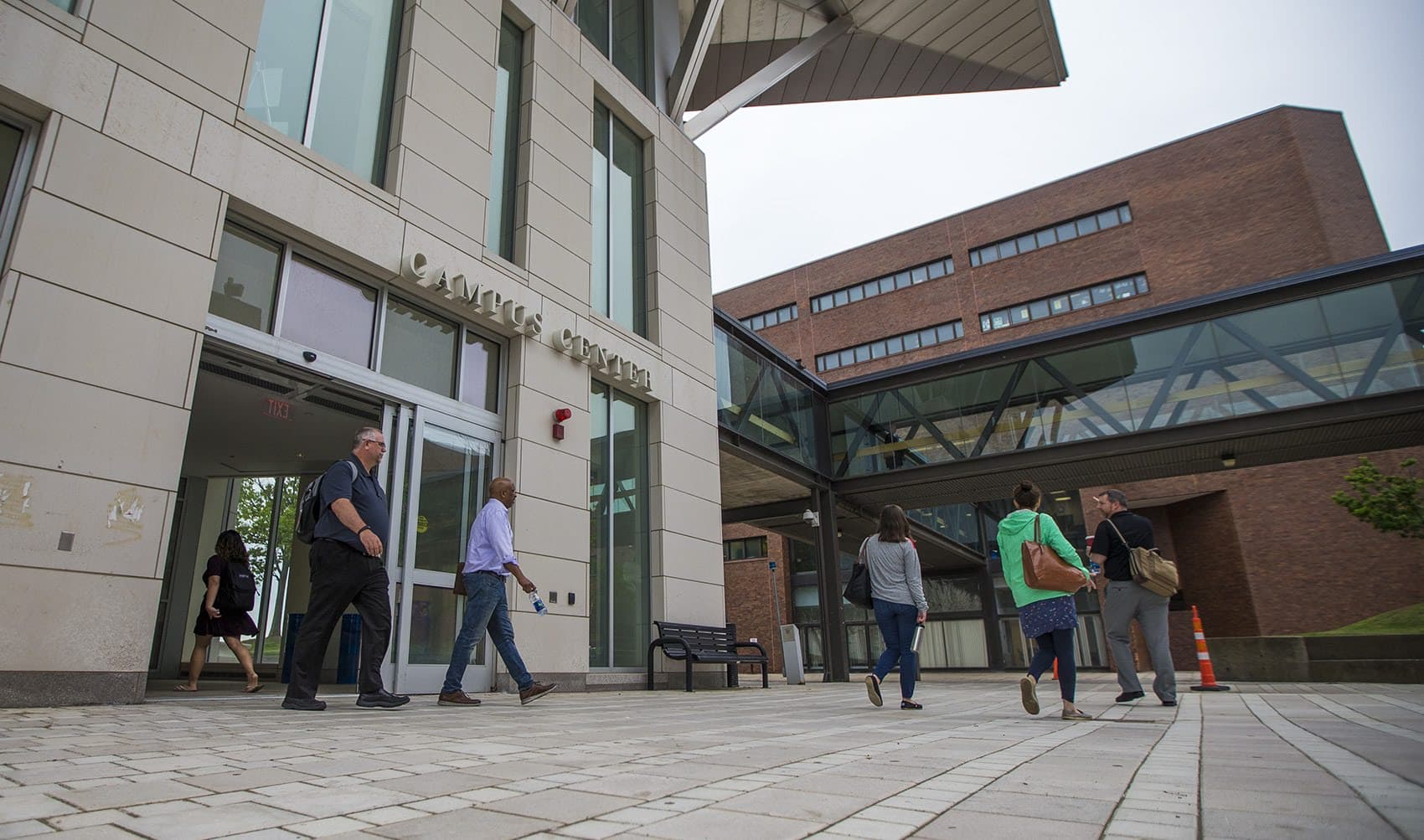 Students and faculty walk out of the Campus Center at UMass Boston. (Jesse Costa/WBUR)