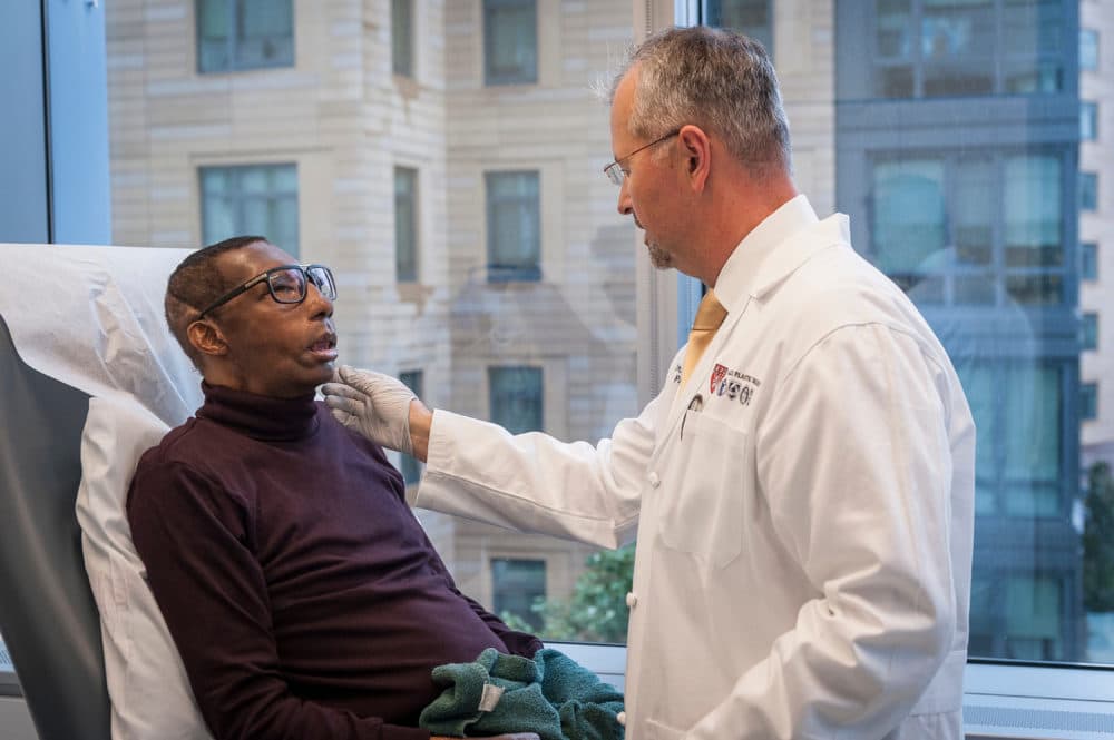 Dr. Bohdan Pomahac examines Robert Chelsea during a check-up following his 2019 face transplant. (J. Kiely Jr./Lightchaser Photography)