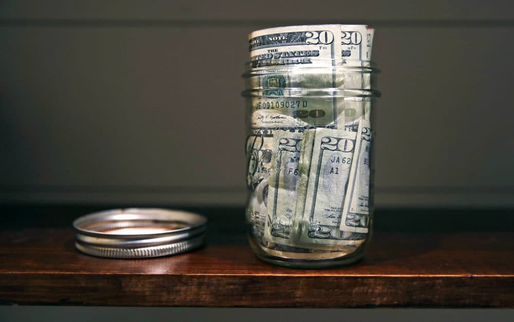 In this June 15, 2018, photo a canning jar filled with currency sits on a shelf in East Derry, N.H. (AP Photo/Charles Krupa)