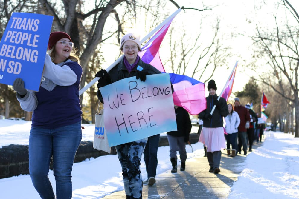 Protesters march outside the South Dakota Capitol in Pierre on Monday, Feb. 10, 2020, as LGBT advocates protested a bill that would ban gender conformation medical treatments for children under 16. (AP Photo/Stephen Groves)