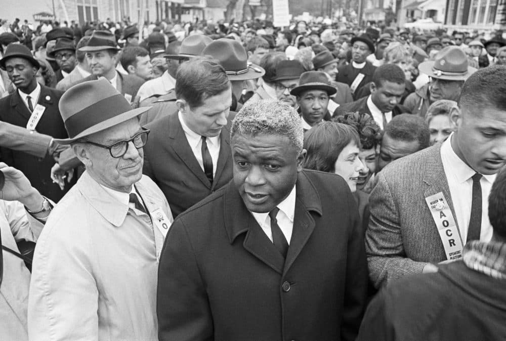 In this March 5, 1964 file photo, former baseball star Jackie Robinson, center, appears with demonstrators in a civil rights march on the capitol in Frankfort, Kentucky. (AP)