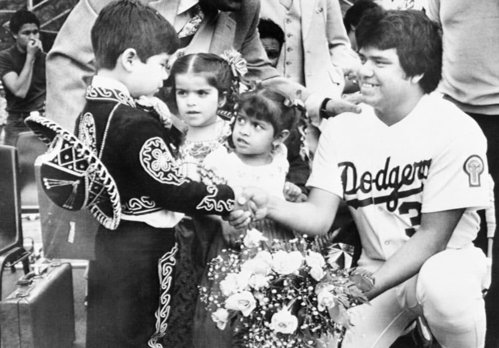 Dodgers pitching ace Fernando Valenzuela receives flowers from three of his fans during a Baseball clinic in Los Angeles on May 16, 1981. The children are from the East Los Angeles section which was mostly a Mexican American neighborhood. (RR/AP)