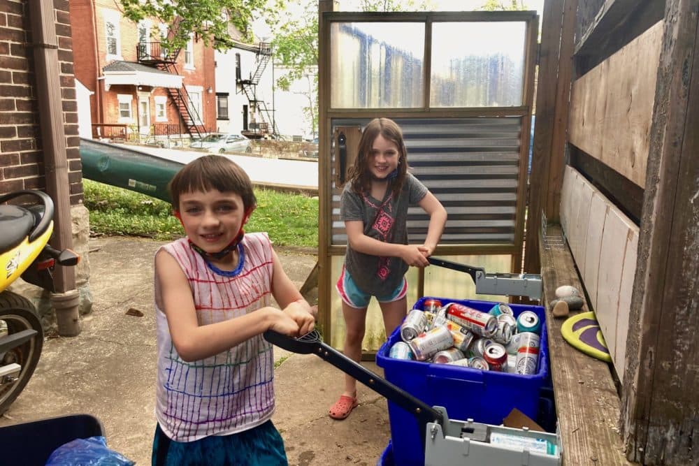 Siblings Teagan and Leo Ellsworth have been collecting — and crushing — cans in their Pittsburgh neighborhood since the pandemic began. (Andy Kubis for The Allegheny Front)