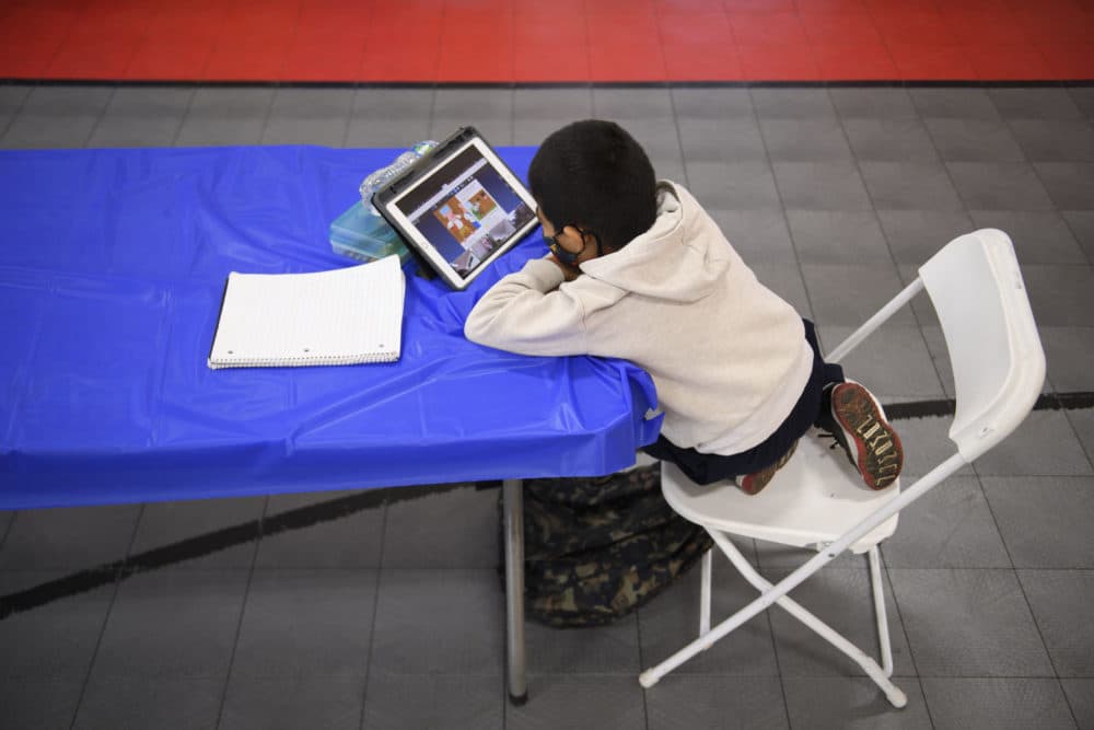 A child attends an online class at a learning hub inside the Crenshaw Family YMCA during the pandemic in February in Los Angeles, California. The learning hub program provides structured distance education resources including free WiFi, electricity, staff support, academic tutoring, and recreation activities to provide a safe environment to support low income and minority communities. (PATRICK T. FALLON/AFP via Getty Images)