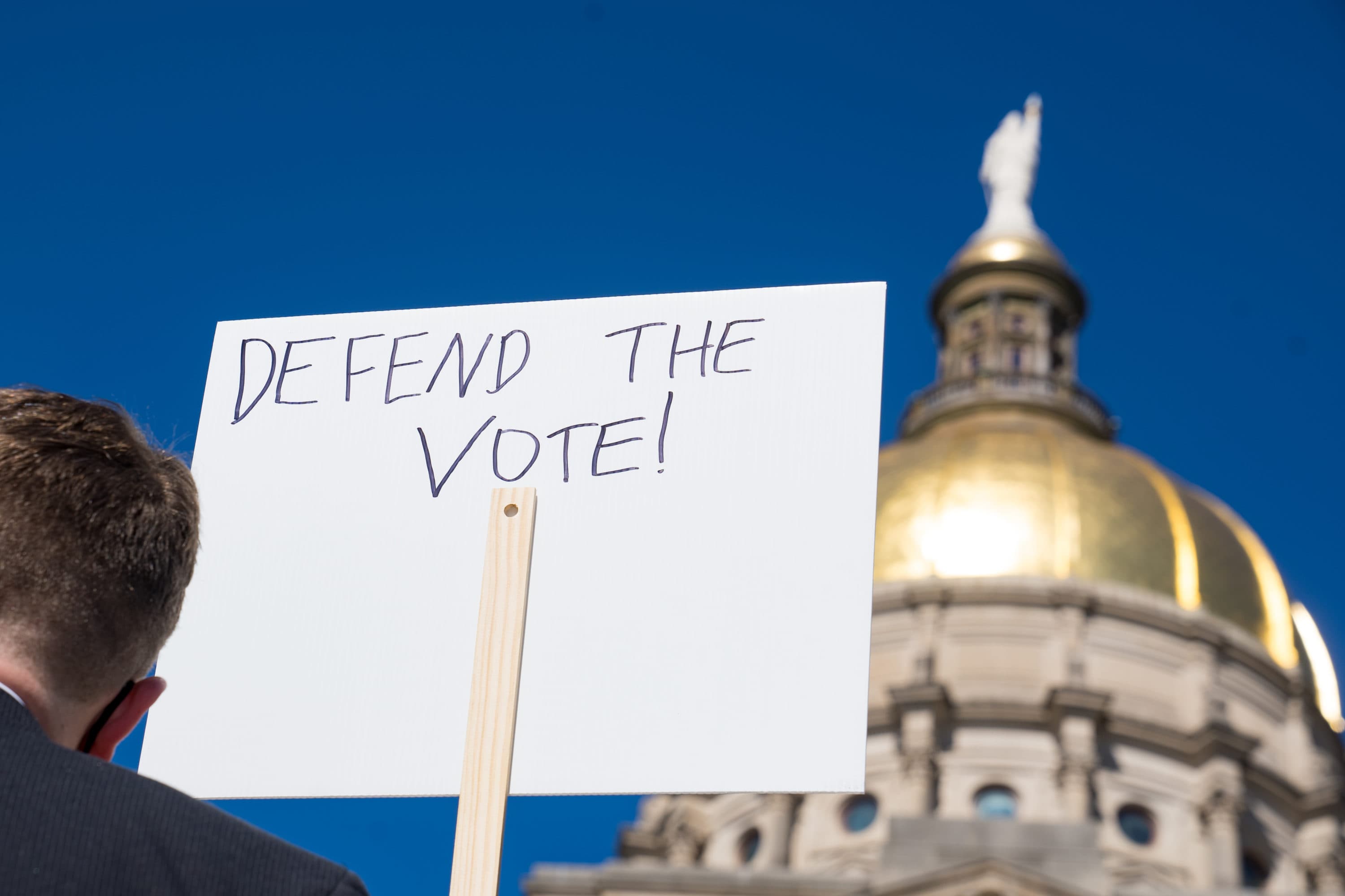 Demonstrators stand outside of the Capitol building in opposition of House Bill 531 on March 8, 2021 in Atlanta, Georgia. HB531 will restrict early voting hours, remove drop boxes, and require the use of a government ID when voting by mail. (Megan Varner/Getty Images)
