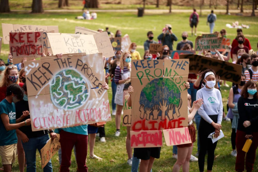 Protesters on March 24, 2021 in Bloomington, Indiana hold placards during the Keep the Promise rally in Dunn Meadow to advocate for Indiana University to reach carbon neutrality by 2040.
(Jeremy Hogan/SOPA Images/LightRocket via Getty Images)