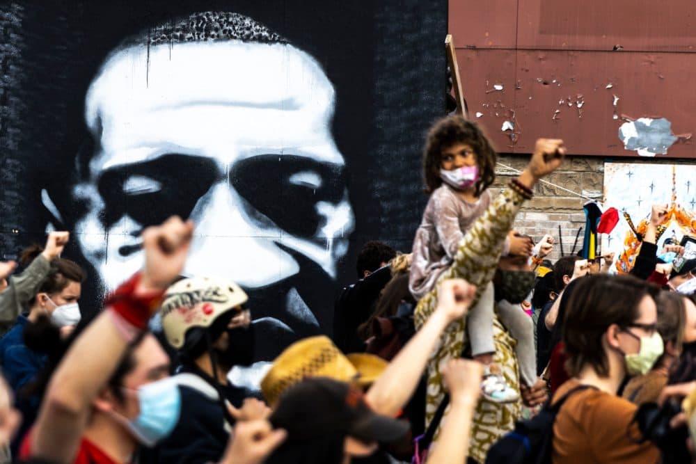 People raise their fists during a demonstration near the George Floyd Memorial in Minneapolis, Minnesota on April 18, 2021 after the shooting death of Daunte Wright. (Kerem Yucel/AFP via Getty Images)