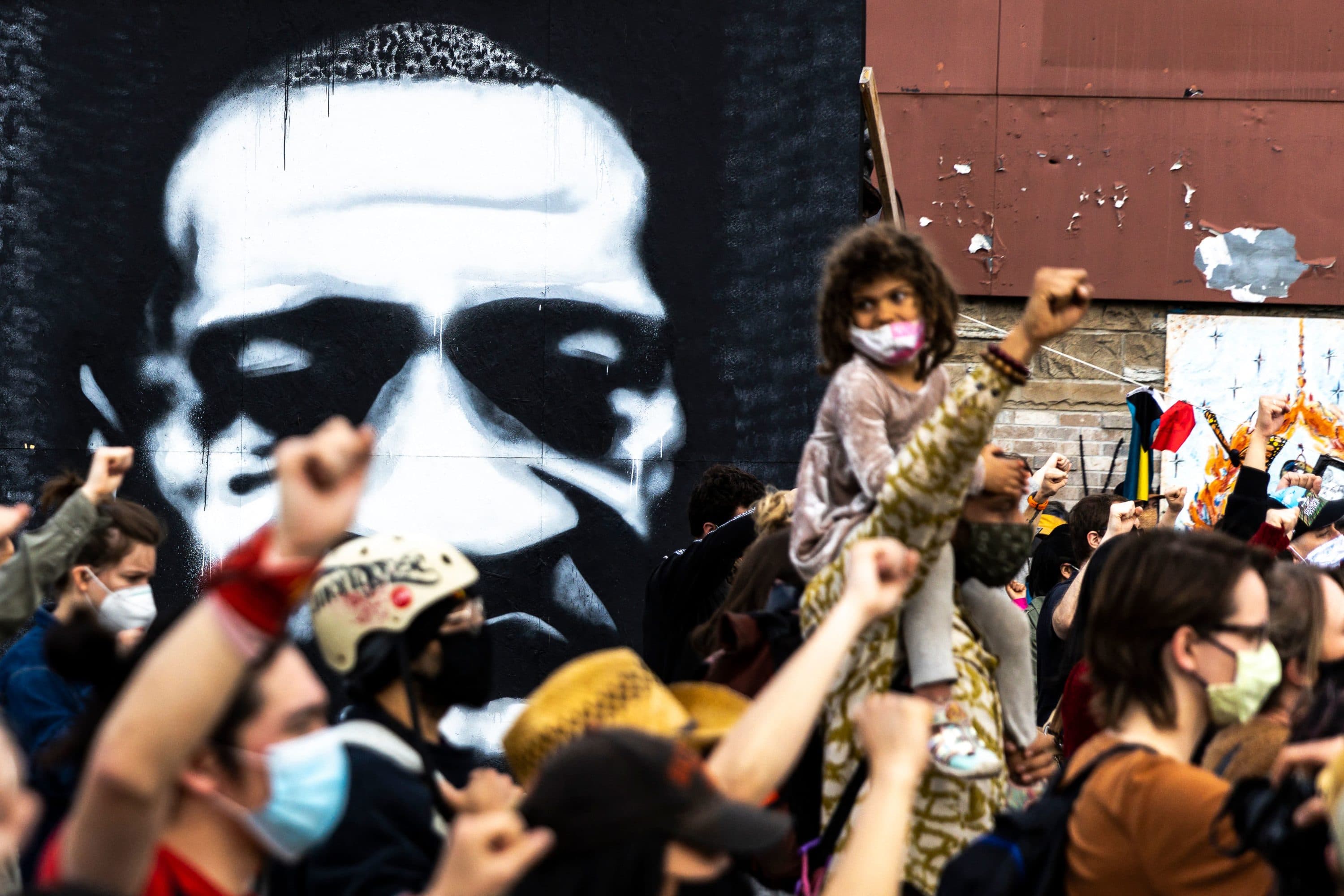 People raise their fists during a demonstration near the George Floyd Memorial in Minneapolis, Minnesota on April 18, 2021 after the shooting death of Daunte Wright. (Kerem Yucel/AFP via Getty Images)
