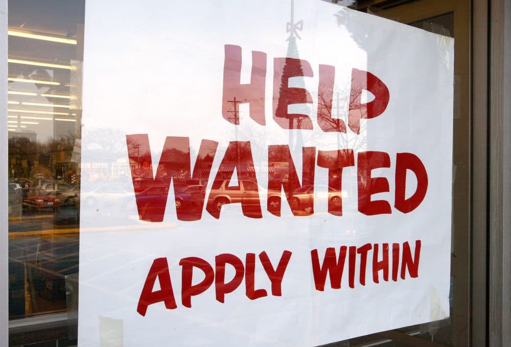 A sign that reads &quot;Help Wanted Apply Within&quot; is seen hanging in a window of a beverage store. (Tim Boyle/Getty Images)