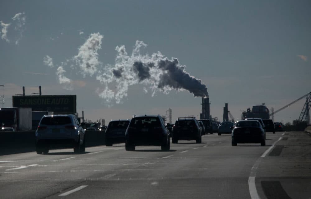 Vehicles move along the the New Jersey Turnpike while a factory emits smoke on November 17, 2017 in Carteret, New Jersey. (Kena Betancur/VIEWpress/Corbis/Getty Images)