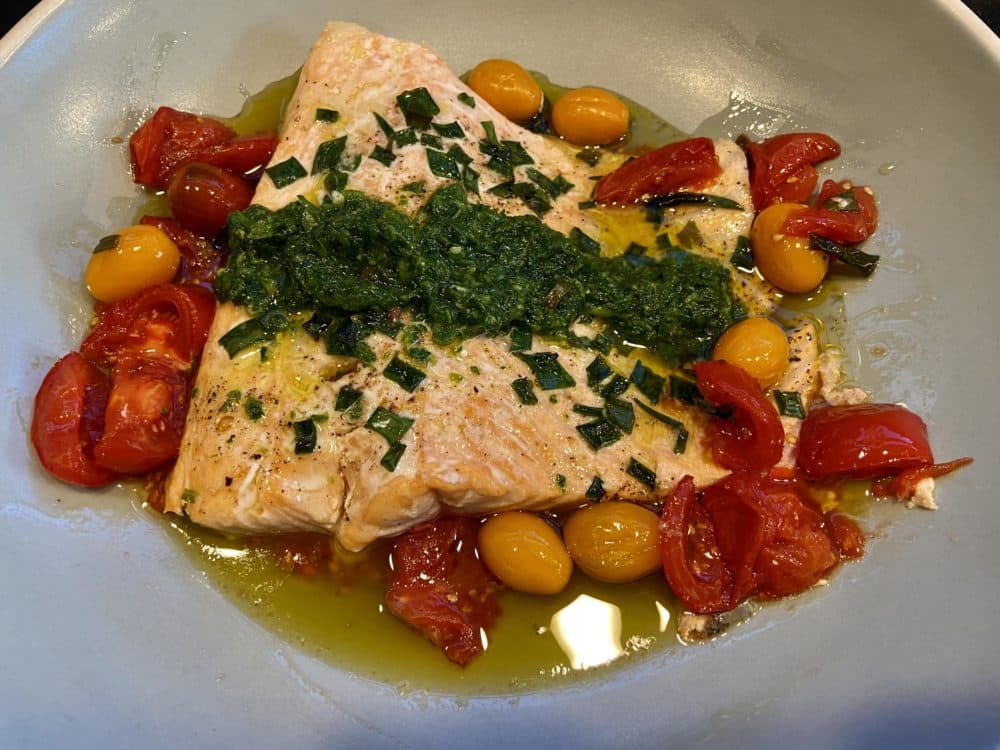Roasted salmon with cherry tomatoes, scallions and green sauce. (Kathy Gunst)