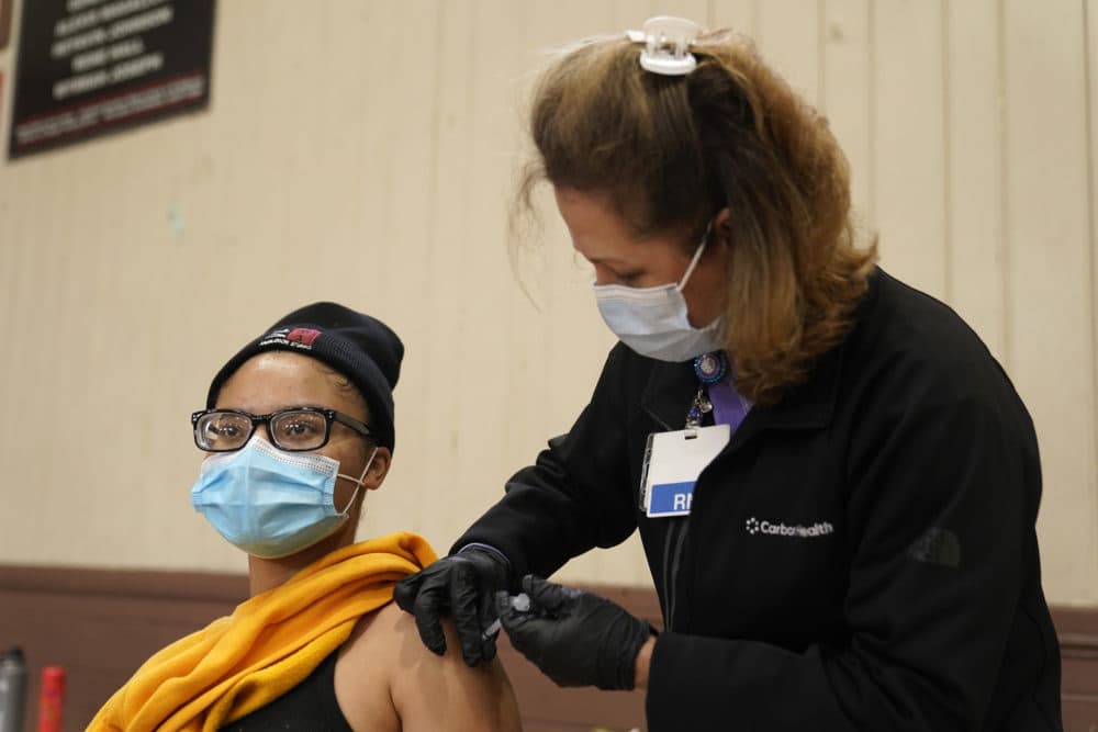 Isis Gardner, left, receives a dose of the Pfizer COVID-19 vaccine at the Banning Recreation Center in Wilmington, Calif. The site switched from its original plan to use the Johnson and Johnson COVID-19 to the Pfizer vaccine. (Marcio Jose Sanchez/AP)