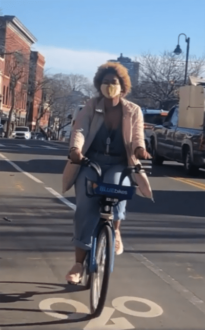 Keona Wynne rides a BlueBike in an Instagram video imploring people to get vaccinated (Screenshot Instagram)